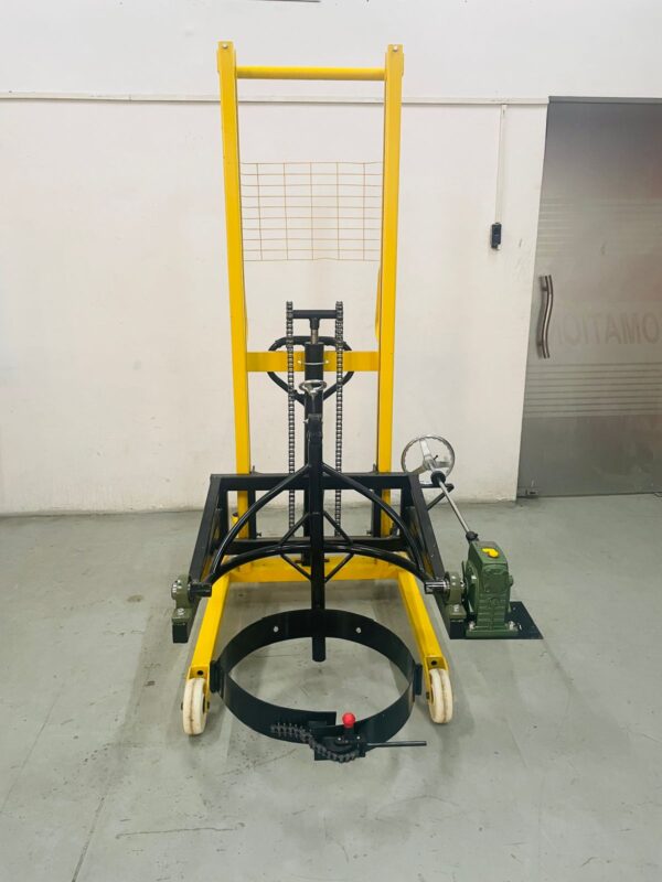 Operator tilting a 210‑litre drum using a manual lifte
